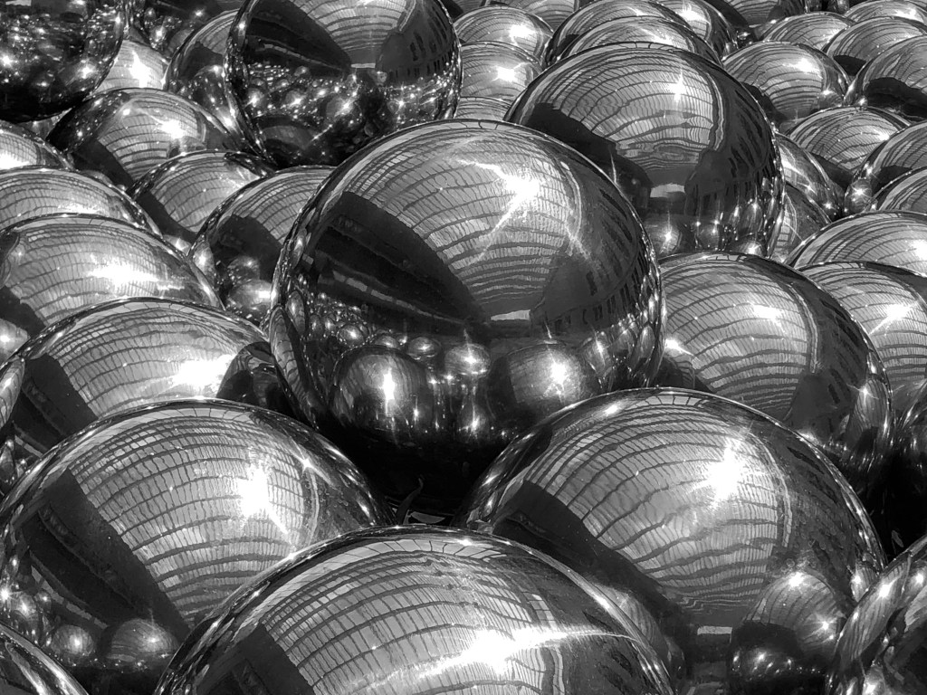 Mirrored spheres in a pile reflecting light from above